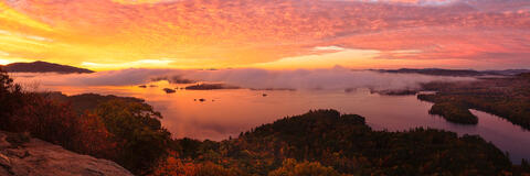 On West Rattlesnake Mountain watching the sun paint the sky a vibrant orange as Squam Lake awakens.