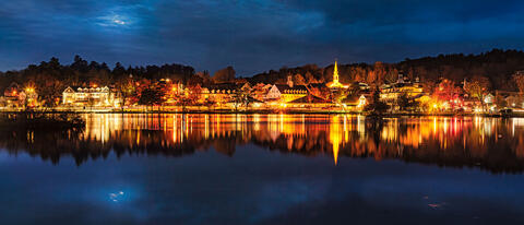 Night time lights shining in on Lake Winnipesaukee in Meredith, NH