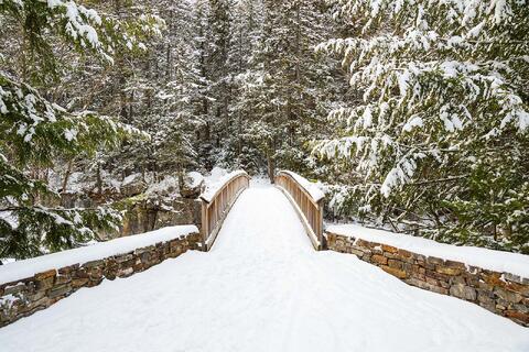 The scenic Rocky Gorge pedestrian bridge in winter on the Kancamagus Hwy in Albany, NH