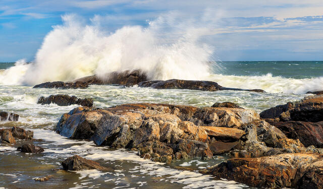 A large storm wave crashes into the shore at Rye Beach. 