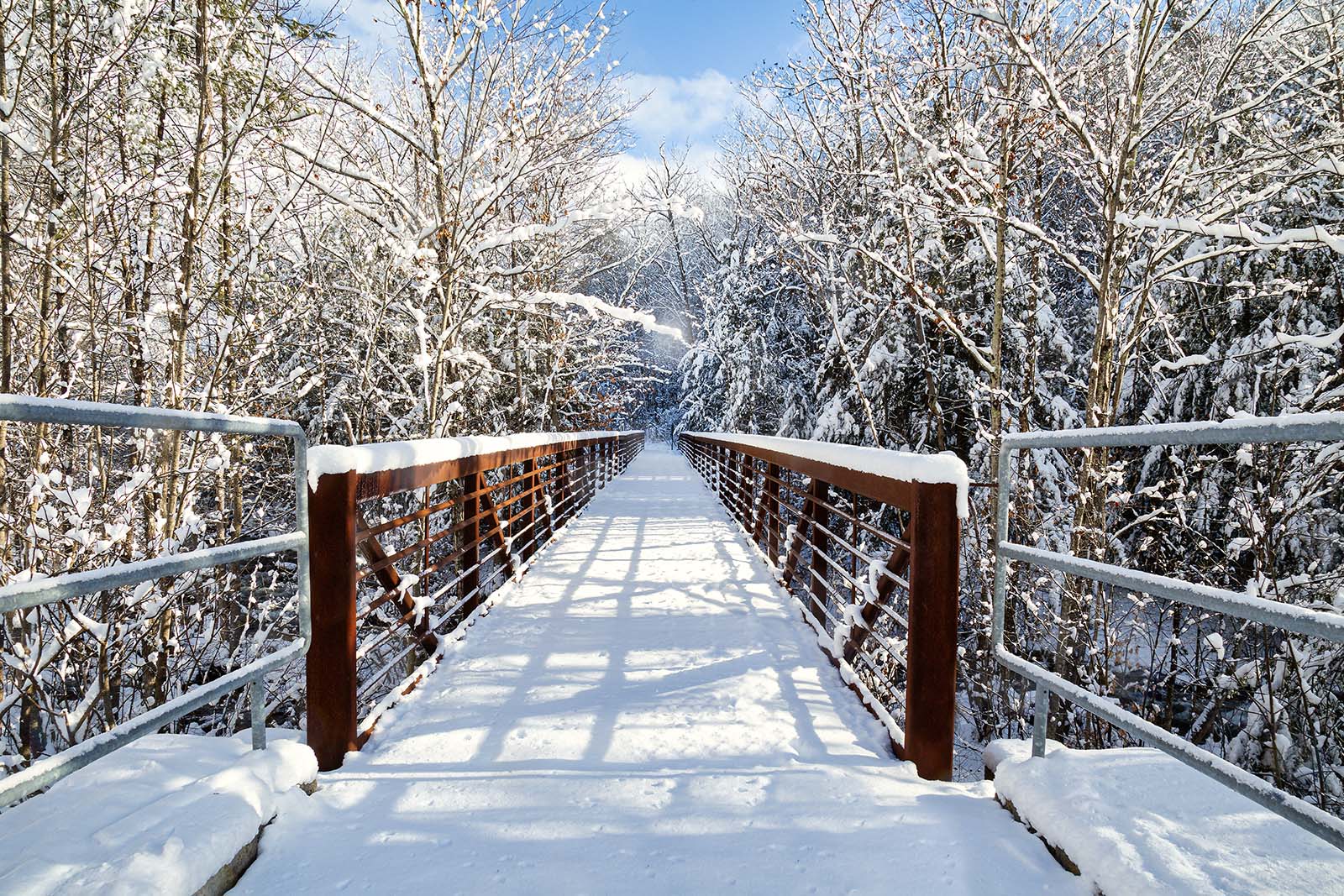 Snowy Foot Bridge Pike Path Pedestrian Bridge covered in a fresh blanket of snow in Bristol, NH