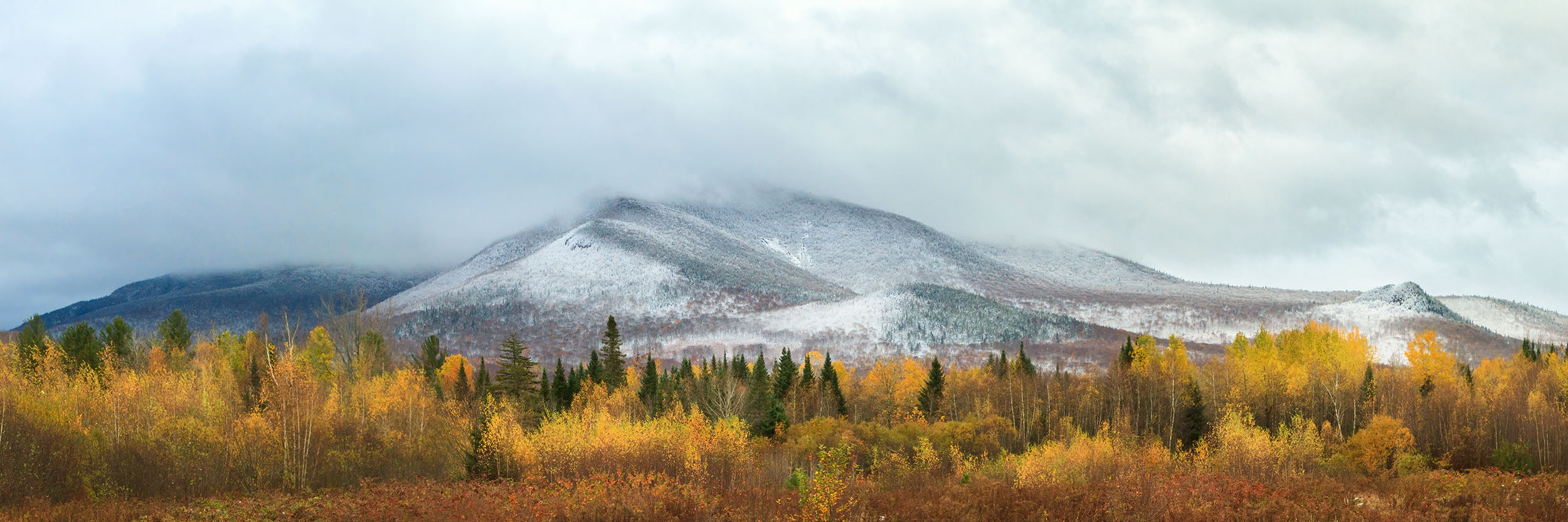 Twin Mountains Snow Field Snow covered Twin Mountains in autumn foliage.